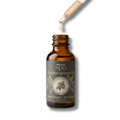 Brown bottle of Omiana Spa Pure Pomegranate Oil with dropper on white background